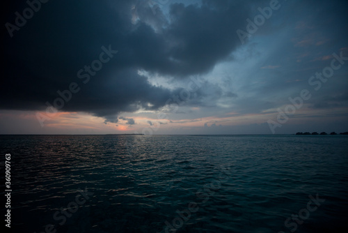 Indian ocean and dark cloudy sunset sky