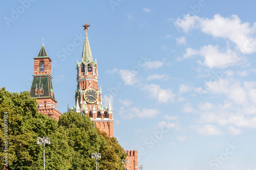 View of Spasskaya Tower of Moscow Kremlin on a summer morning. Blue sky with few clouds in the background. Copy space for your text.