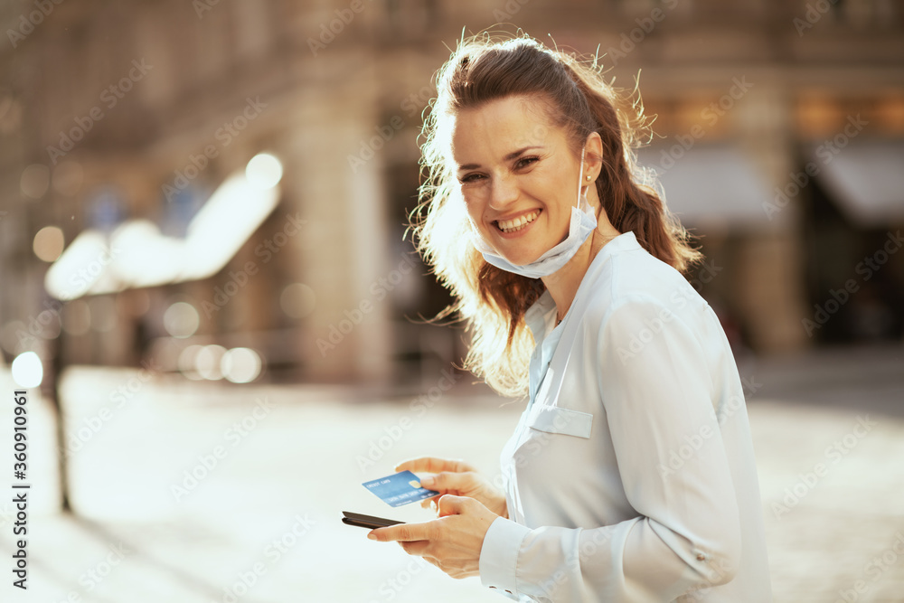 happy woman buying online outdoors on city street happy woman buying online outdoors on city street