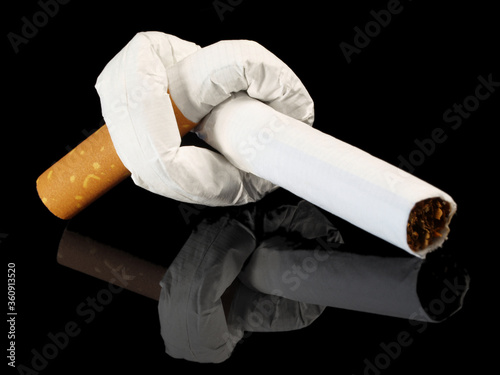 Cigarette with Knot isolated on black Background - Stop Smoking