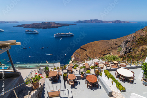 View of the Aegean Sea from the panoramic terraces of the city of Fira, in the background you can see Tholos Naftilos, Santorini, Greece
