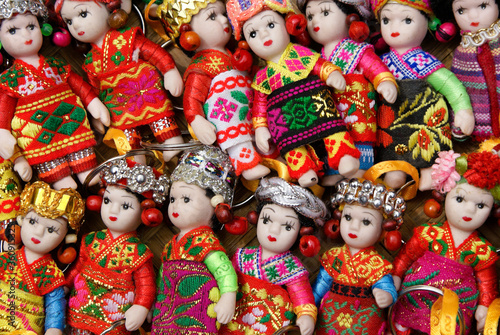 Colorful little dolls in ethnic dress for sale as keychain fobs in market, Dali, Yunnan Province, China