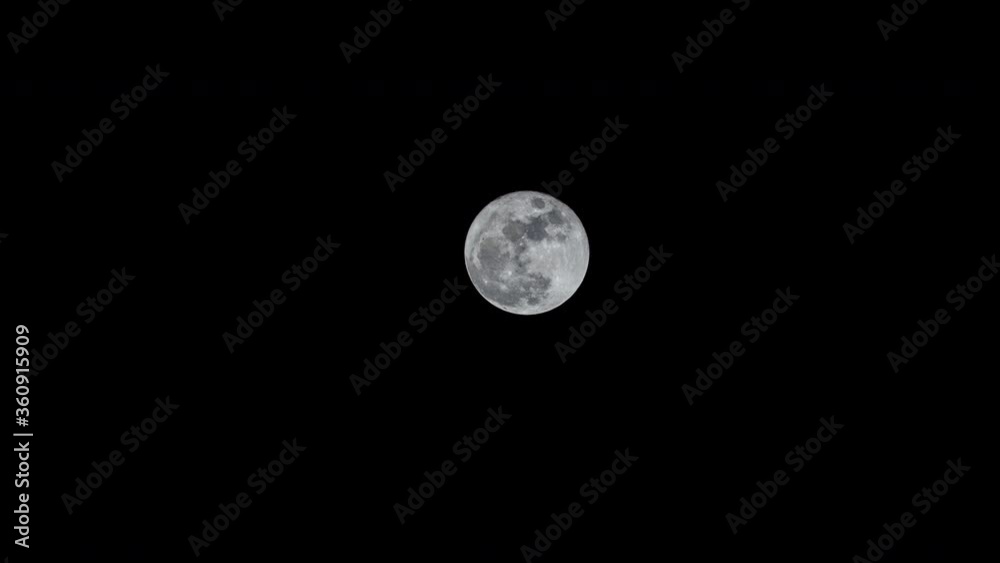 Full moon time lapse through dark sky Full moon time lapse through dark sky