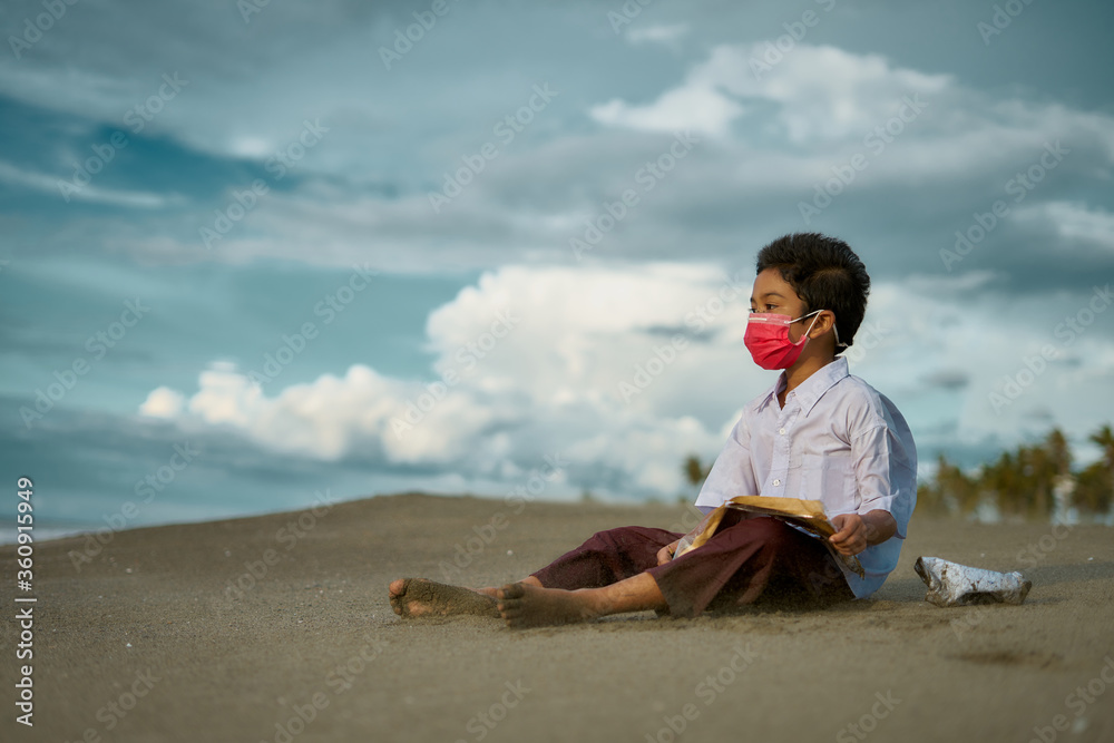 Little boy study hard, doing homework outdoor under cloud and blue sky. Homeschooling, New normal - concept Little boy study hard, doing homework outdoor under cloud and blue sky. Homeschooling, New normal - concept