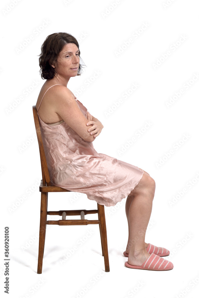 side view of a woman sitting with nightgown on white background, side view look side side view of a woman sitting with nightgown on white background, side view look side