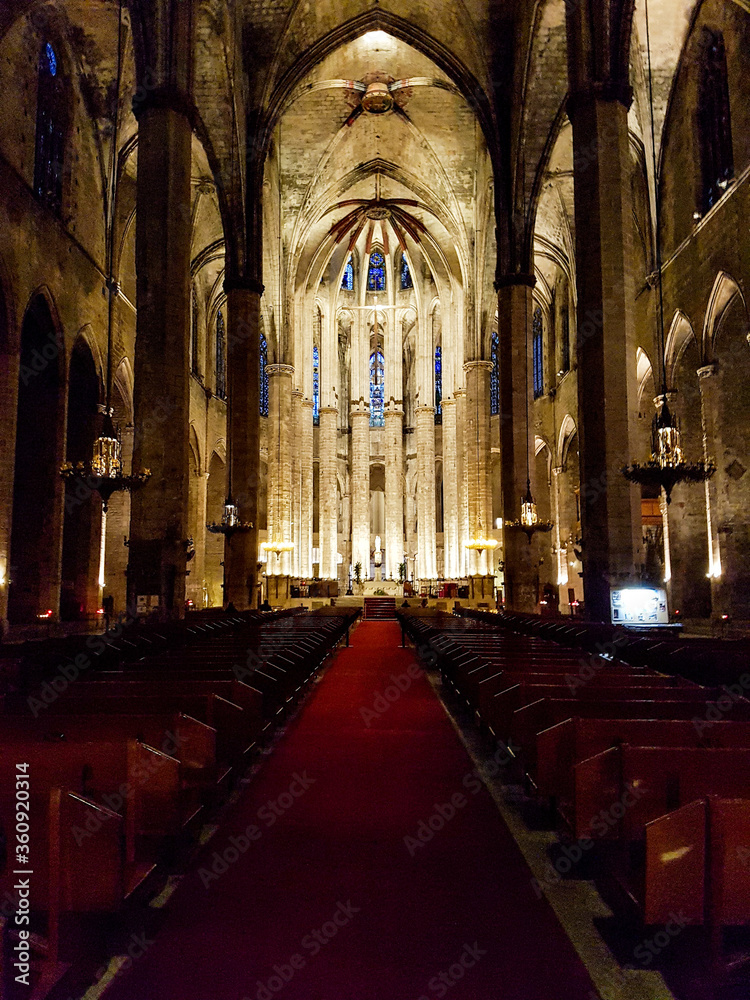 Inside empty church seats row red carpet indoor cathedral stones historic light altar shine religious Barcelona spain
