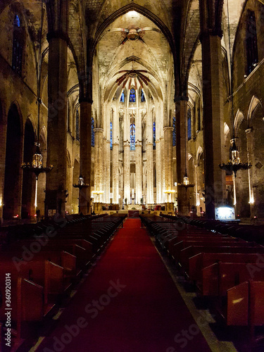 Inside empty church seats row red carpet indoor cathedral stones historic light altar shine religious Barcelona spain
