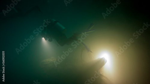 The scuba girl's vision is clouded inside the cloud of sulfide acid from the Mexican cenote. Yucatan (Mexico)