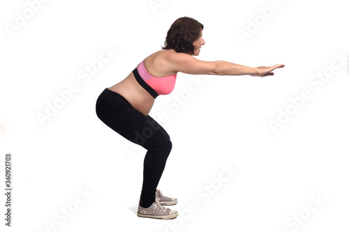 portrait of a pregnant woman exercising on white background © curto