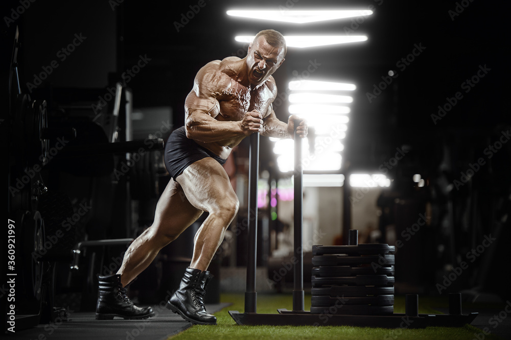 bodybuilder fitness man pumping up legs muscles