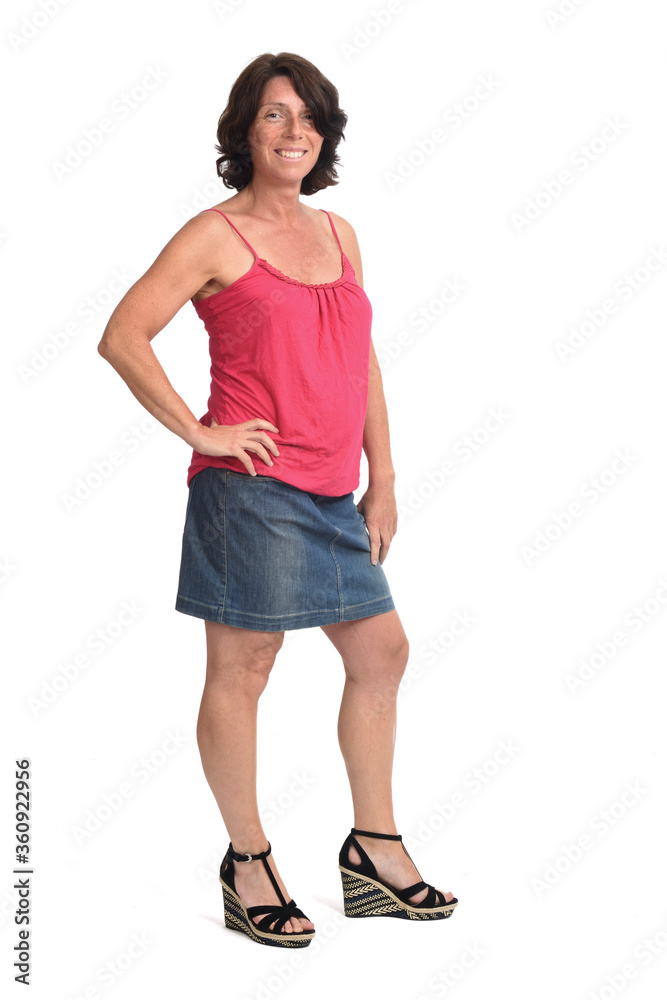 woman with denim skirt on white background, hands on hip woman with denim skirt on white background, hands on hip