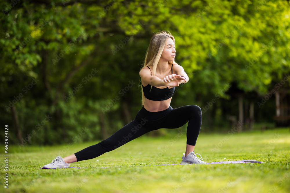 Healthy young fit woman stretching before fitness and Exercise in park