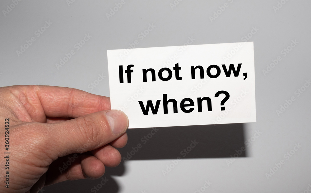 Message on the card IF NOT NOW, WHEN in hands of businessman. Message on the card IF NOT NOW, WHEN in hands of businessman.