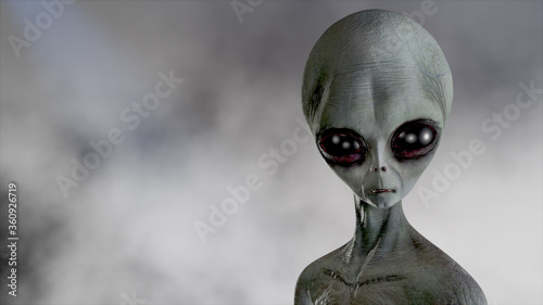 Scary gray alien walks and looks blinking on a dark smoky background. UFO futuristic concept. 3D rendering.