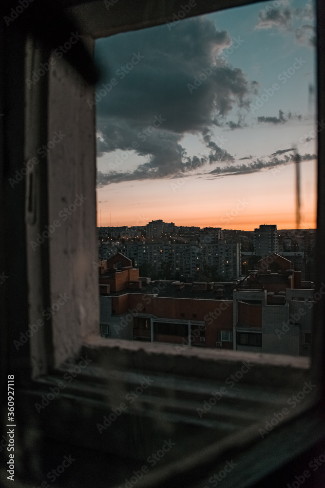 sunset over the city through the window