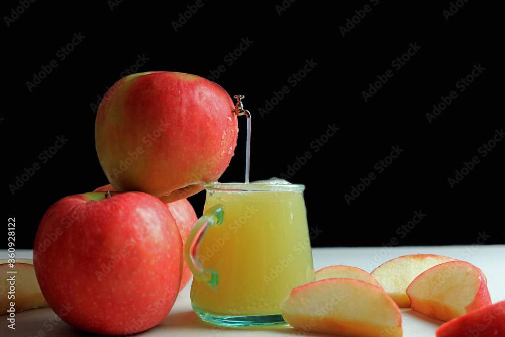 A small scale model tap extracting fresh apple juice from an apple. A small scale model tap extracting fresh apple juice from an apple.