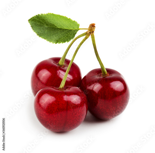 Three sweet cherries with cherry leaf