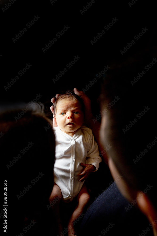 Young father and mother holding their newborn baby son. Mom, dad and baby. Happy family concept. Copy space Young father and mother holding their newborn baby son. Mom, dad and baby. Happy family concept. Copy space