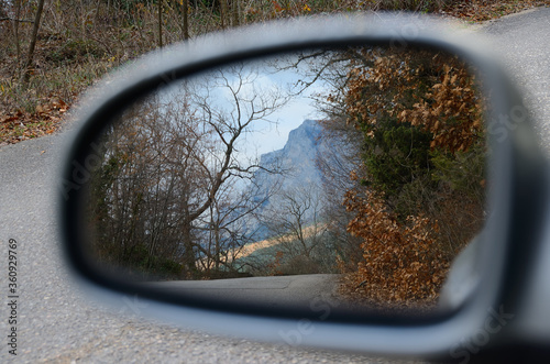 Mountain landscape reflected in the rearview mirror