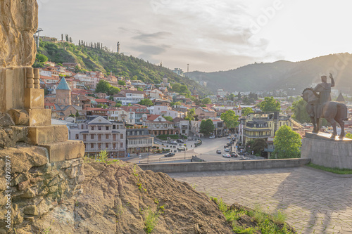 Cityscape of Old Tbilisi with King Vakhtang Statue, colorful houses and churches from the Metechi cliff in the evening photo