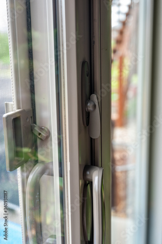 Handle, locking hardware, and jam to a sliding glass and screen door.