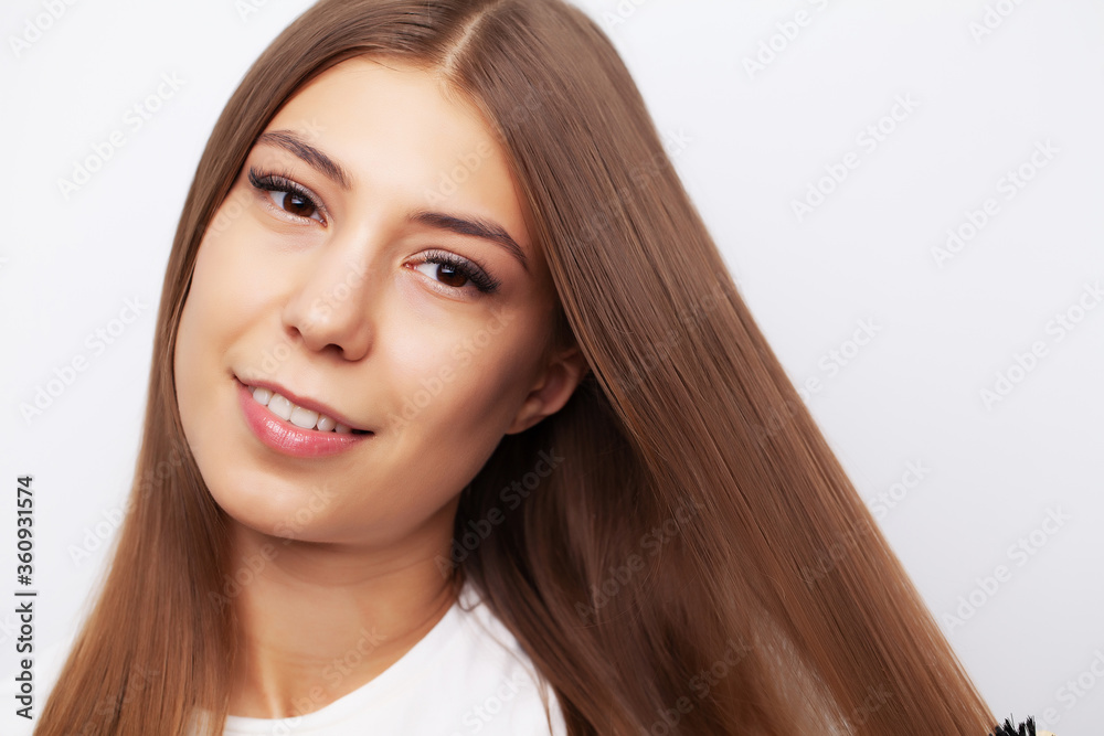 Young female model with beautiful long hair combs his comb Young female model with beautiful long hair combs his comb