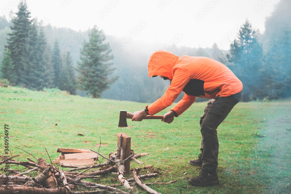 a portrait of an urban man, migrated to a village farm, he is chopping wood a portrait of an urban man, migrated to a village farm, he is chopping wood