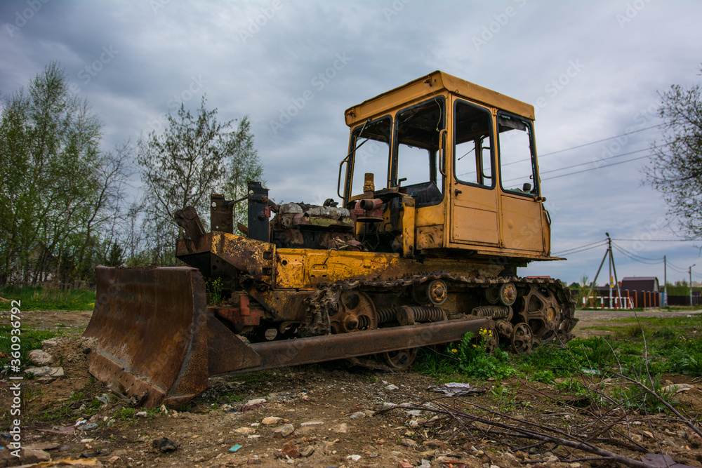 Broken tractor on tracks in the field Broken tractor on tracks in the field
