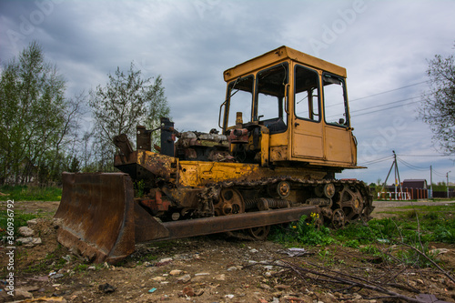 Broken tractor on tracks in the field © SUN_art