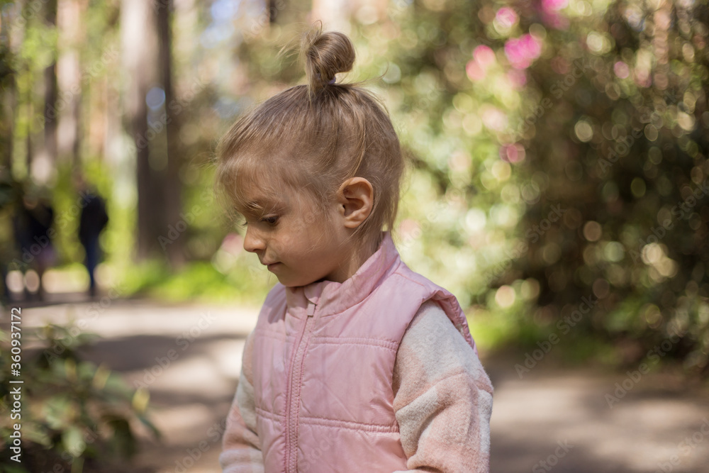 Cute adorable little caucasian child girl enjoy standing in forest during walk .Dreaming and feel free. Freedom lifestyle. Cute adorable little caucasian child girl enjoy standing in forest during walk .Dreaming and feel free. Freedom lifestyle.