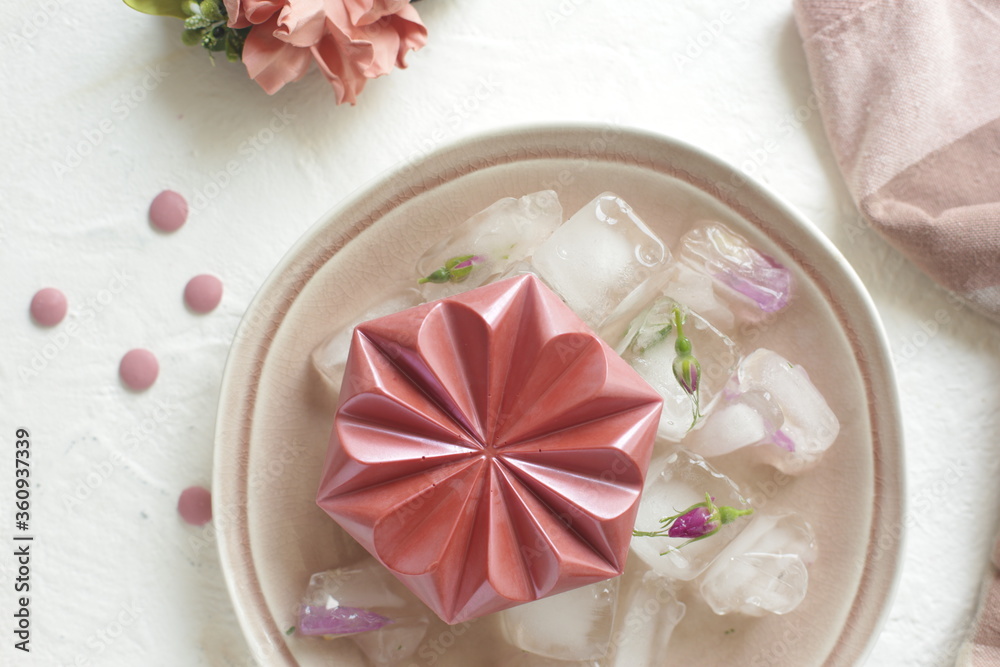 Pink chocolates lie on ice. Place for photo.
Pink chocolates lie on ice. Place for photo.