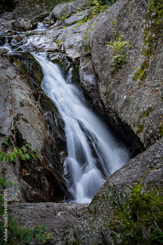 Few autumn leaves surround waterfall near Blue Ridge Parkway