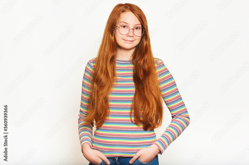 Φωτογραφία Studio portrait of pretty young teen girl with long red hair, posing on white ba