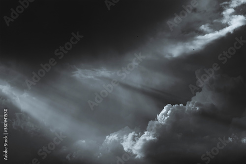 Black-and-white tinted image of dark clouds in the evening