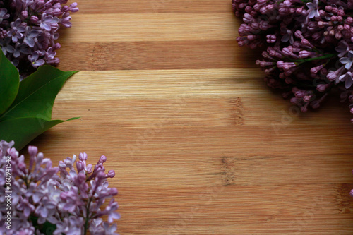 lilac flowers on wooden background © Жанна Киселева