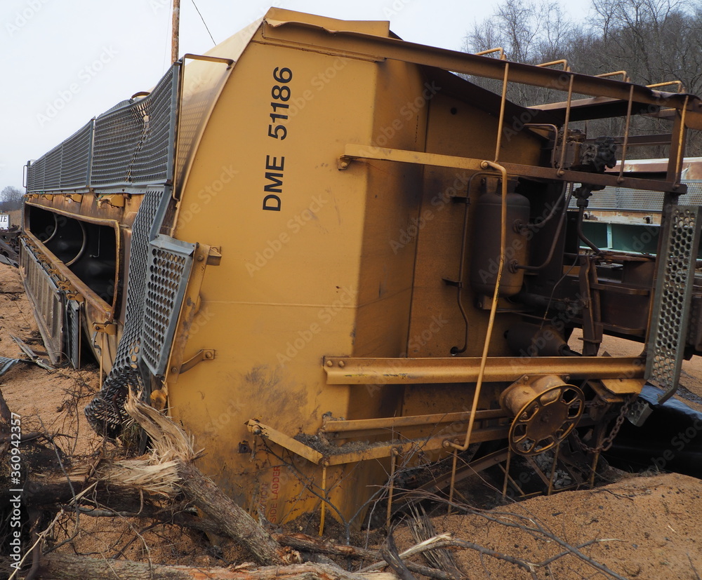 Fototapeta premium Train wreck with grain hopper car on its side
