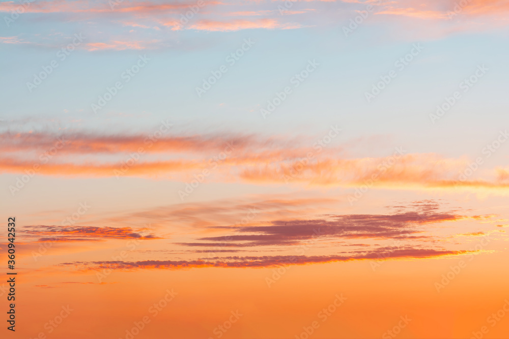 Fototapeta premium Blue sky at sunset with bright stains of orange and pink.
