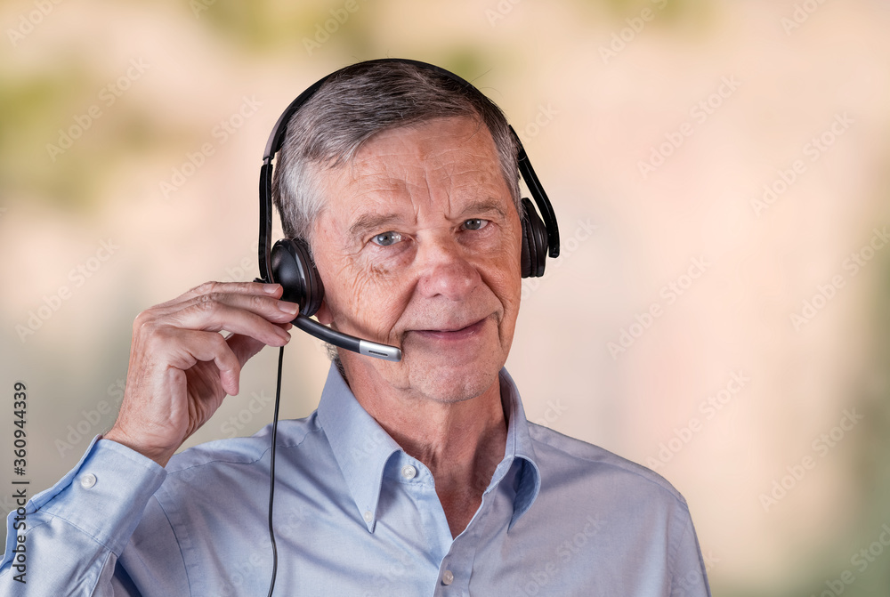 Senior caucasian man using headset to talk to customers or team in work from home. Senior caucasian man using headset to talk to customers or team in work from home.