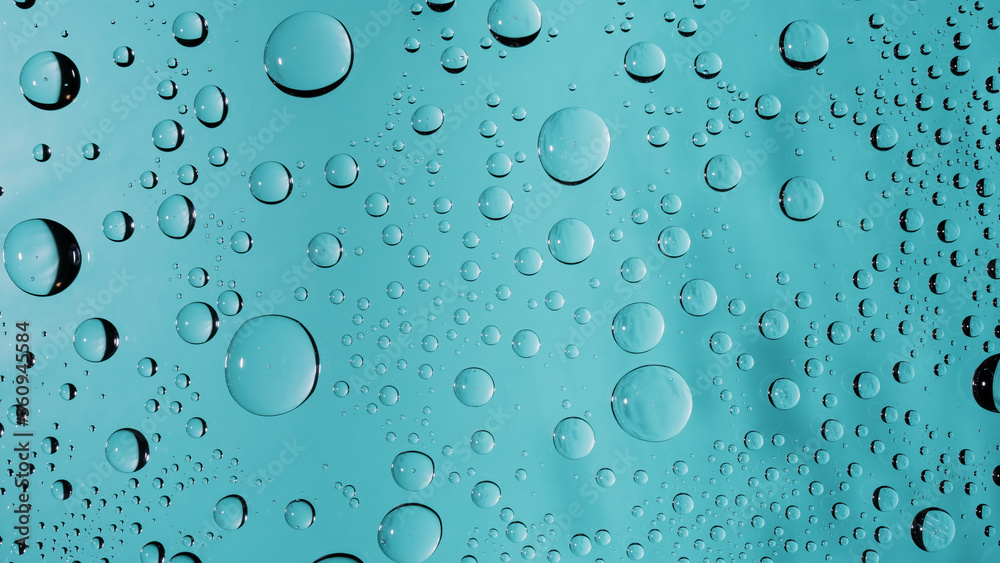 Water drops on turquoise colored glass window surface background. Clear transparent water droplets macro beading wallpaper Water drops on turquoise colored glass window surface background. Clear transparent water droplets macro beading wallpaper
