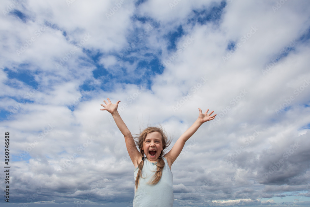 Little girl having fun against sky clouds outdoors Little girl having fun against sky clouds outdoors