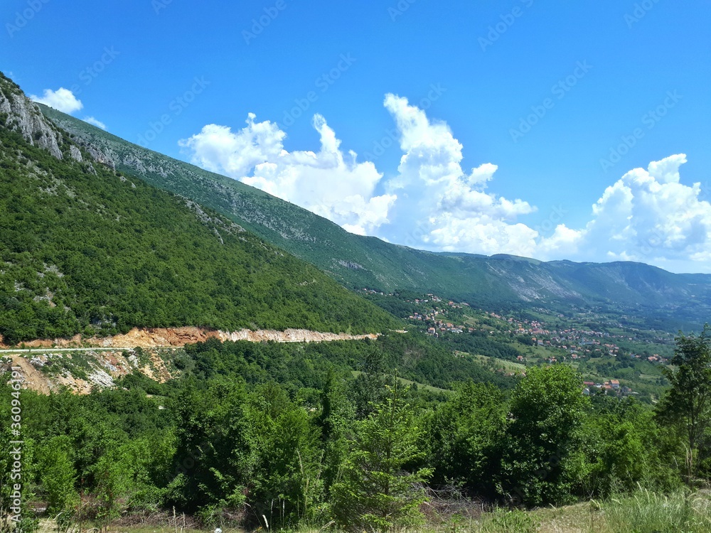 Naklejka premium Mountain landscape with mountains and clouds