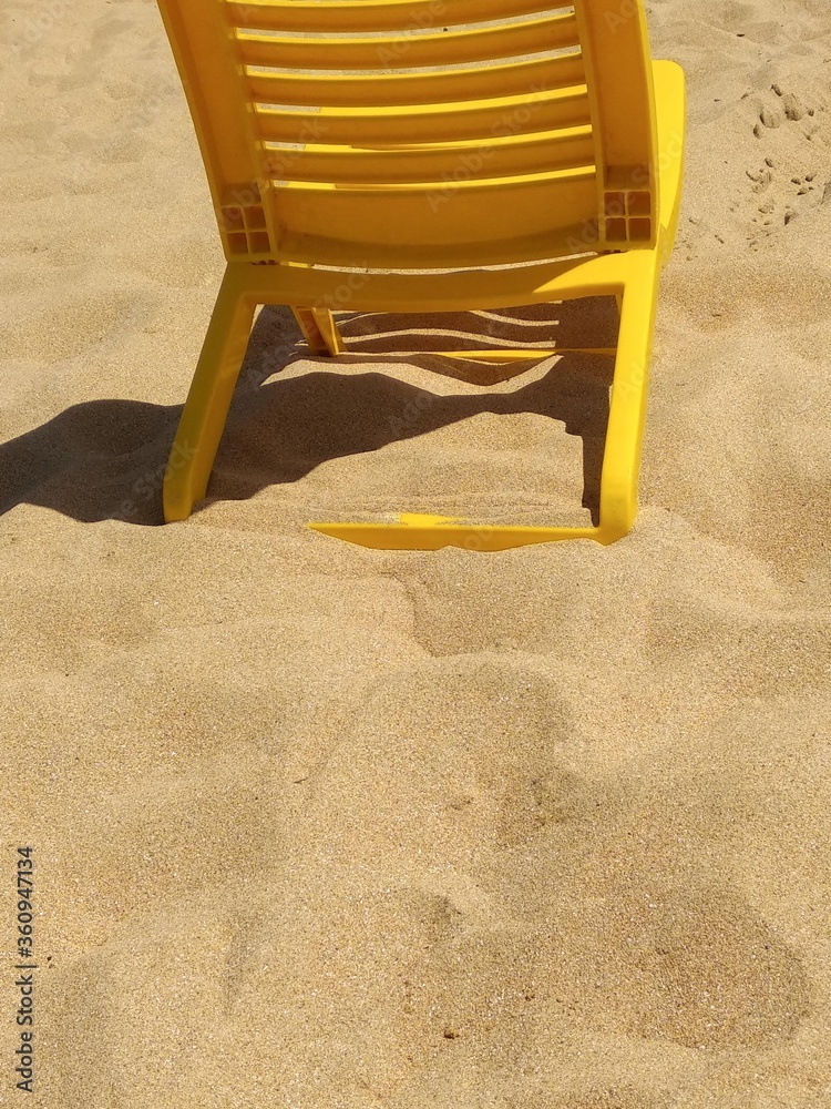 yellow chair placed on the beach in summer yellow chair placed on the beach in summer
