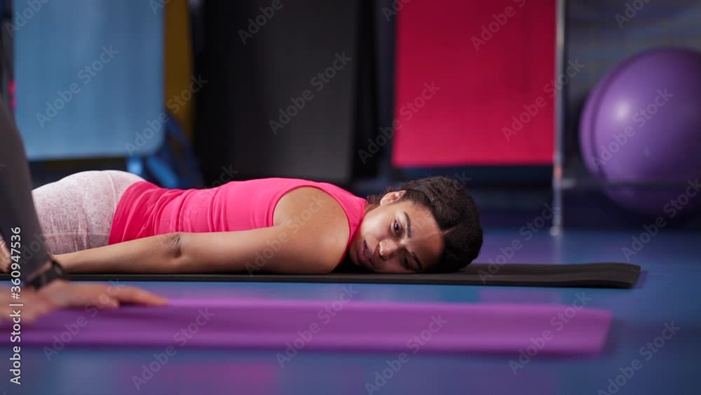 Girls relaxing on mats after training in gym Girls relaxing on mats after training in gym