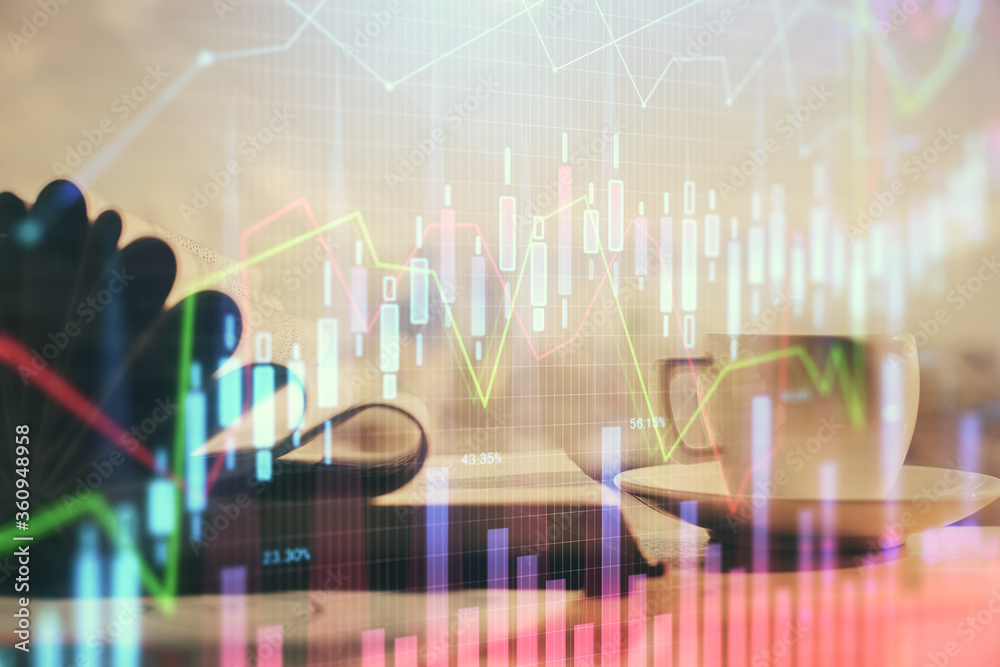 Double exposure of financial chart drawing and desktop with coffee and items on table background. Concept of forex market trading Double exposure of financial chart drawing and desktop with coffee and items on table background. Concept of forex market trading