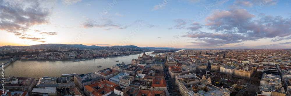 Panoramic Aerial drone shot of Hungarian Parliament Kossuth Square by Danube river in Budapest sunset