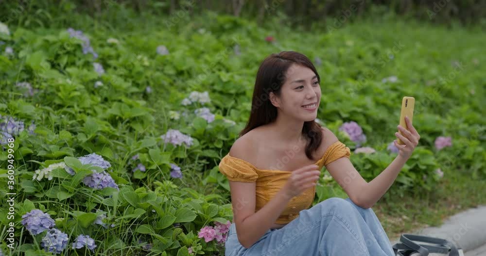 Woman take selfie on cellphone in hydrangea field Woman take selfie on cellphone in hydrangea field