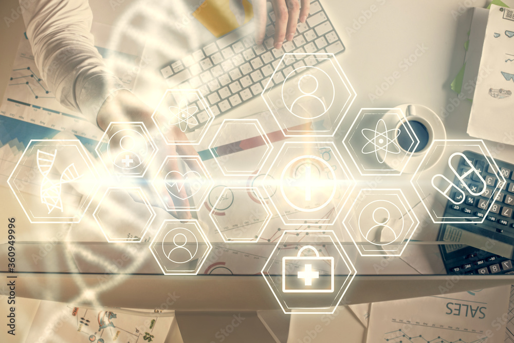 Fototapeta premium Double exposure of man's hands typing over computer keyboard and DNA hologram drawing. Top view. Medical education concept.