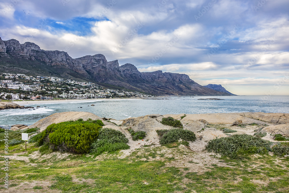 Wonderful Camps Bay nature (Kampsbaai) before sunset - affluent suburb of Cape Town. Camps Bay bordered by spectacular Twelve Apostles Mountain and glittering Atlantic Ocean. Camps Bay, South Africa.