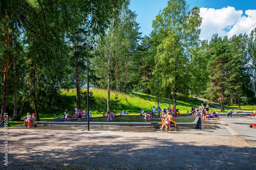 Amazing outskirts of Helsinki : kids playing in pool of small depth and forest