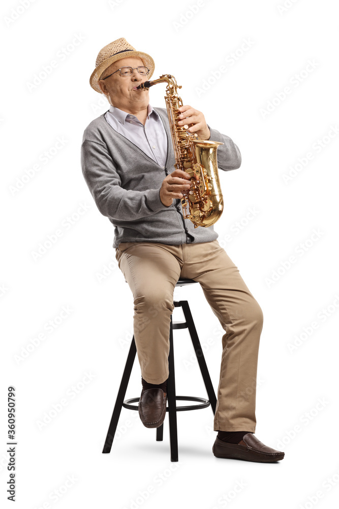 Naklejka premium Elderly man musician playing a sax and sitting on a chair
